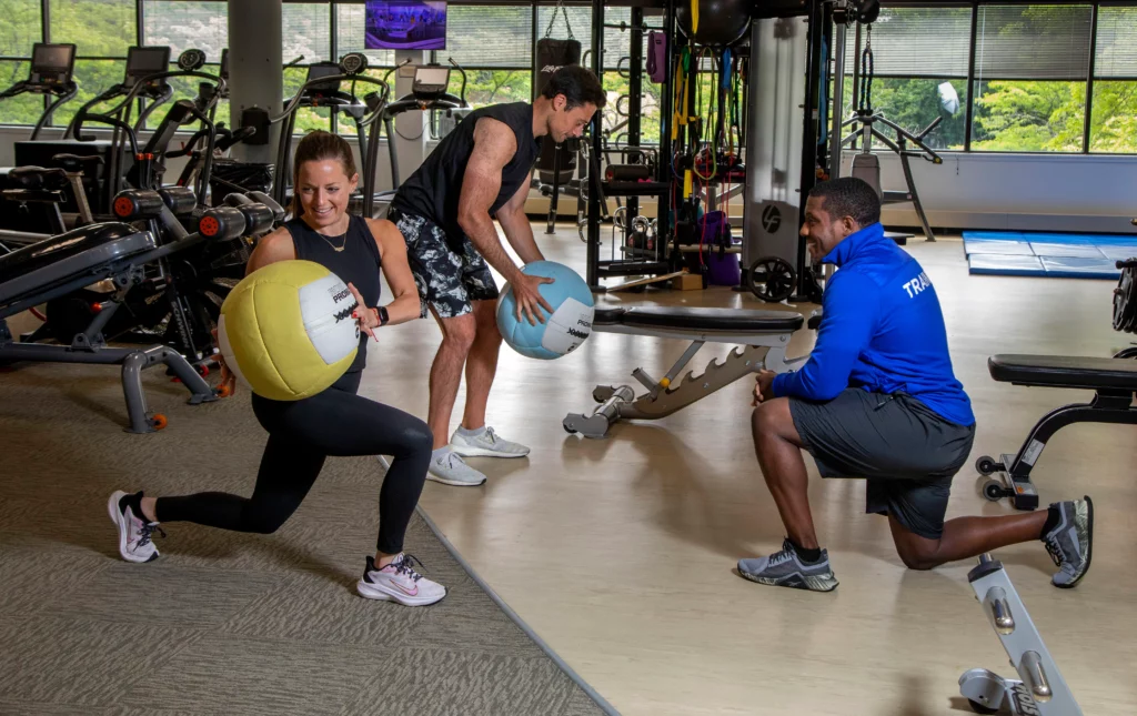 Partner workout with a medicine ball and trainer