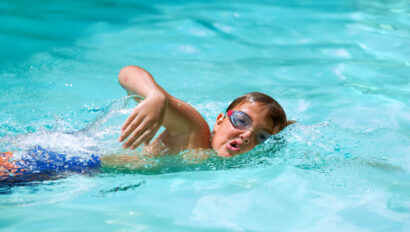 Boy swimming the breast stroke.