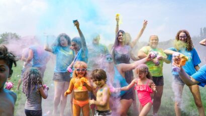 children playing and throwing colorful powder.