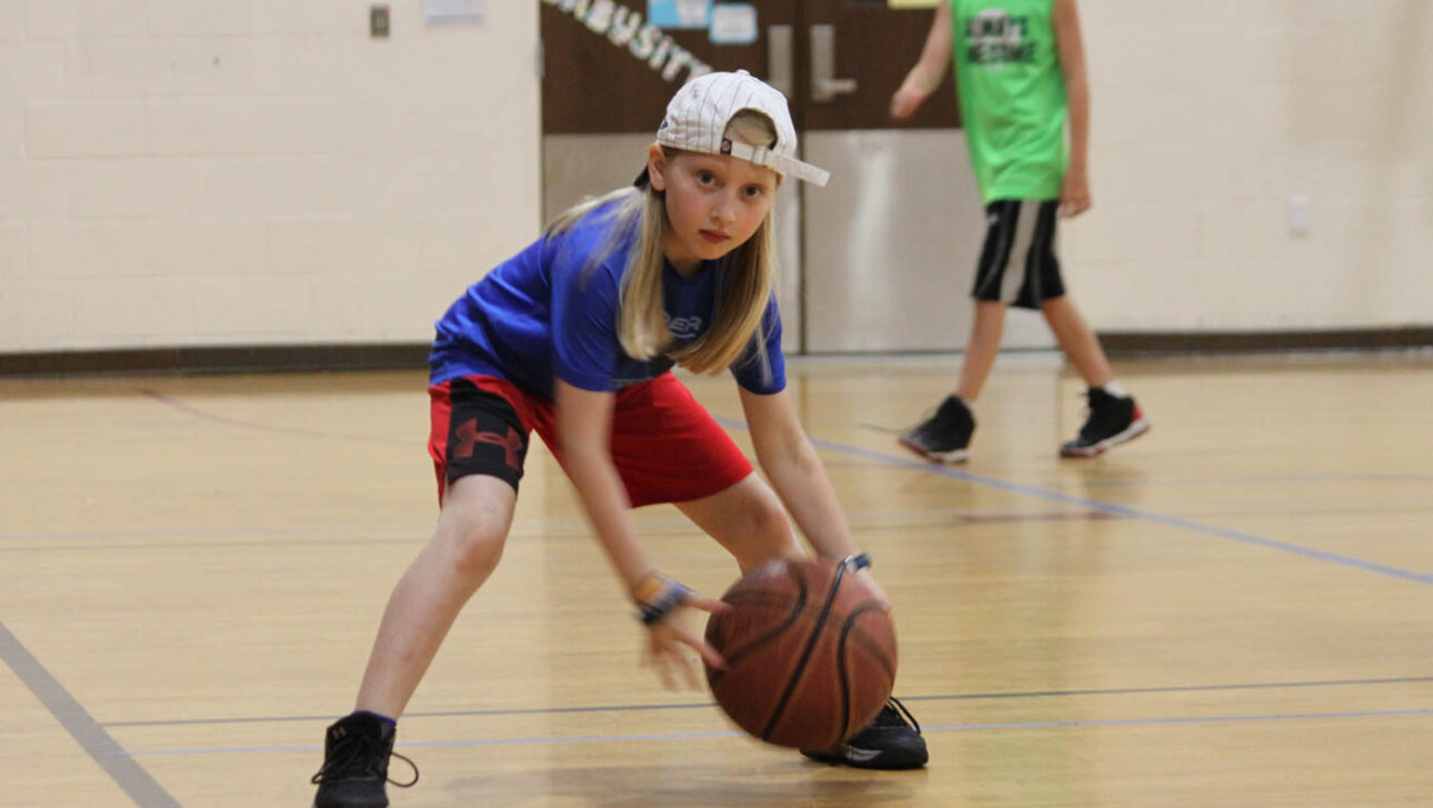 Girl playing basketball.