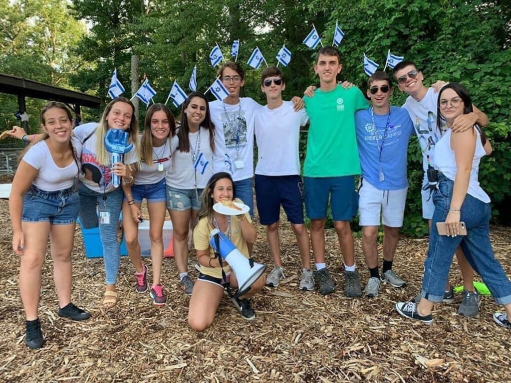 Group of counselors with Israeli flags in their hair.