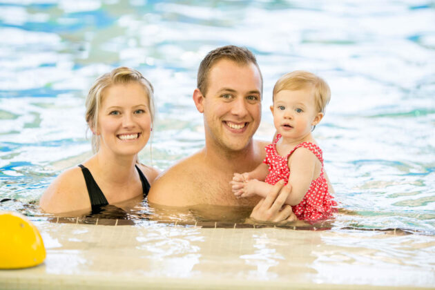 Mom, dad, and baby in the pool