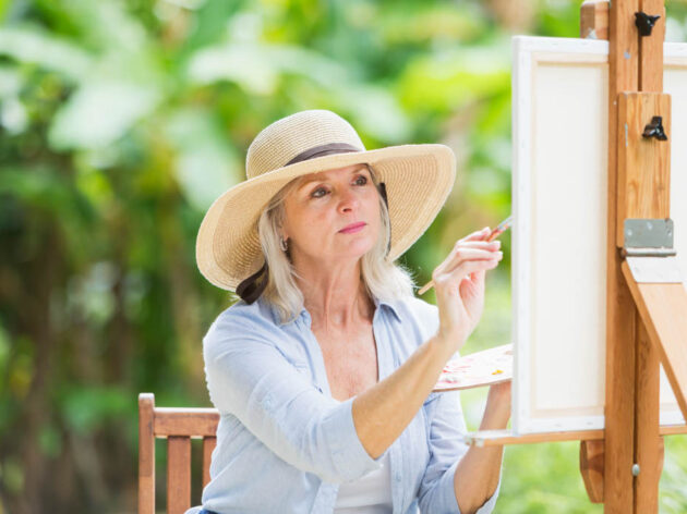 Woman painting outside.