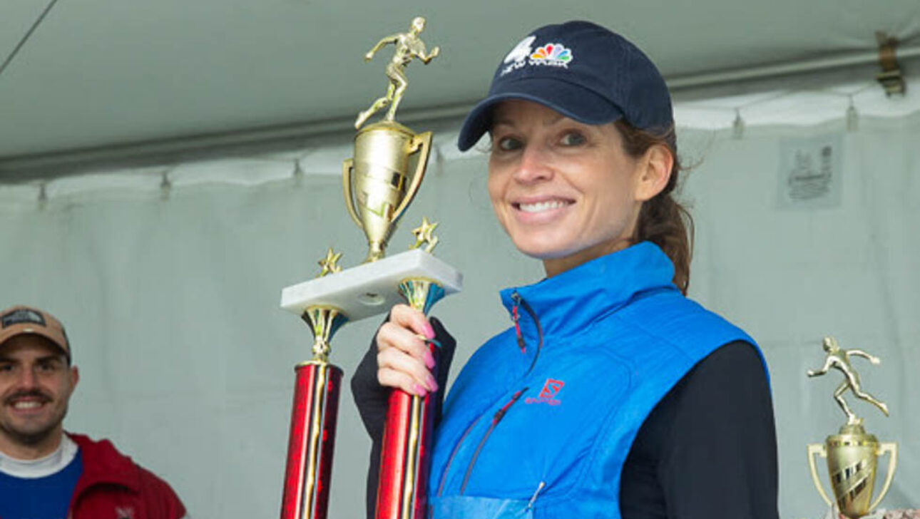 Woman holding a trophy.