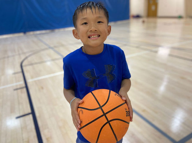 boy holding basketball ready to shoot
