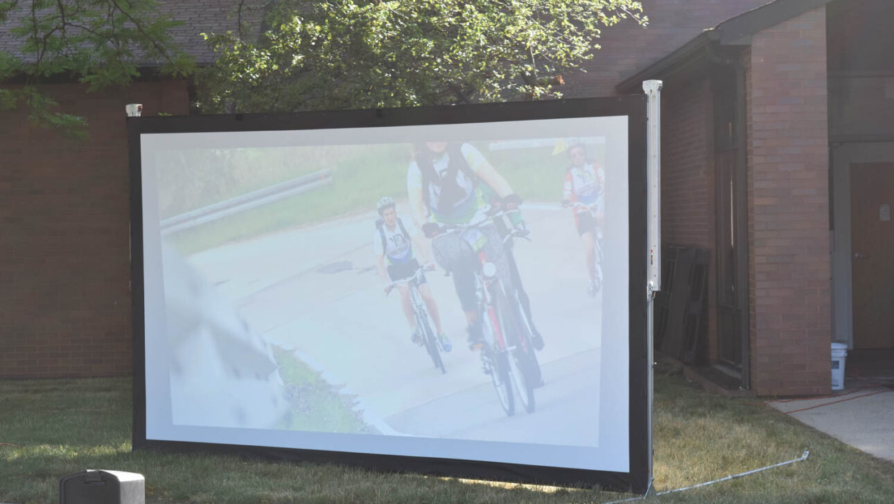 Large outdoor screen with event video.