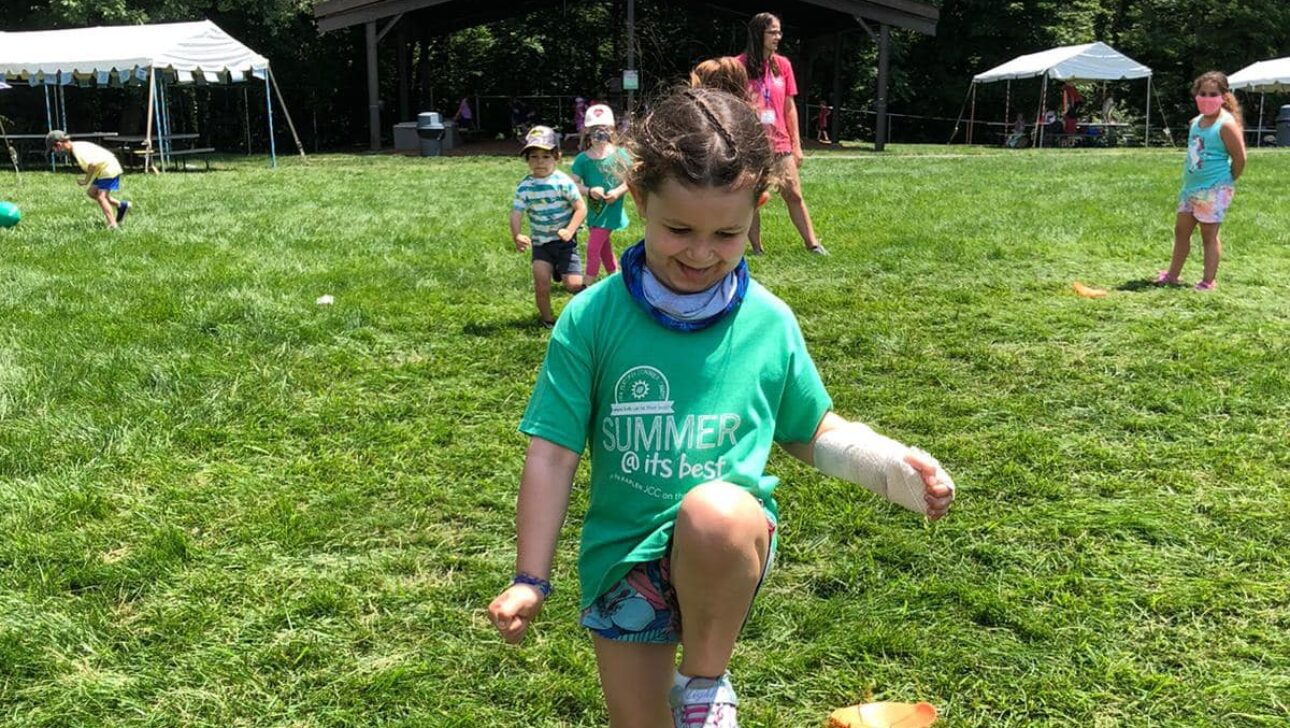 Child playing outside and happy.