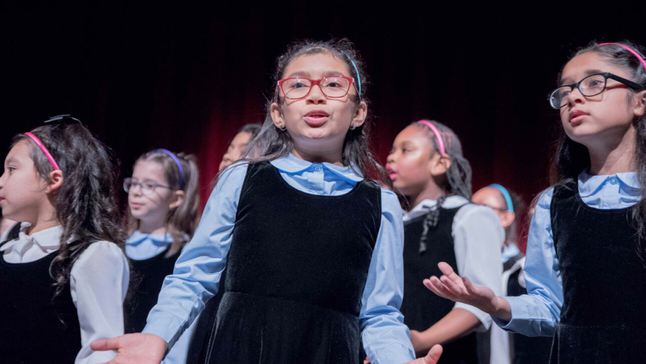 Girls singing on stage.