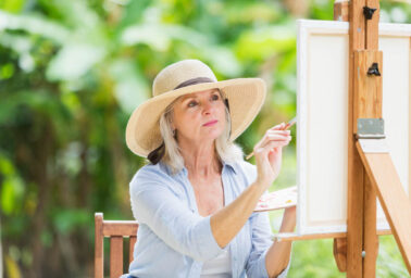 Woman painting outside.