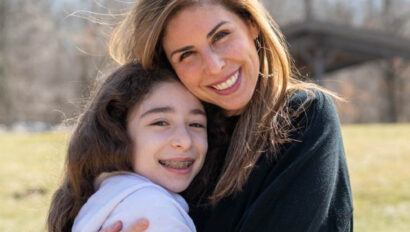 Mother hugging daughter.