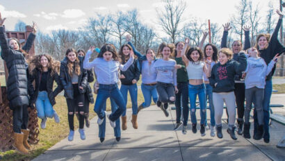 Group of teen girls jumping in the air.