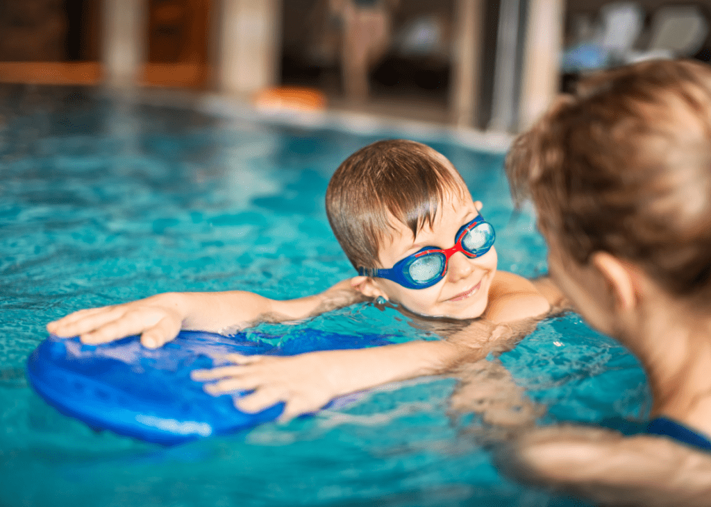 Swim instructor guiding a student at Kaplen JCC on the Palisades.